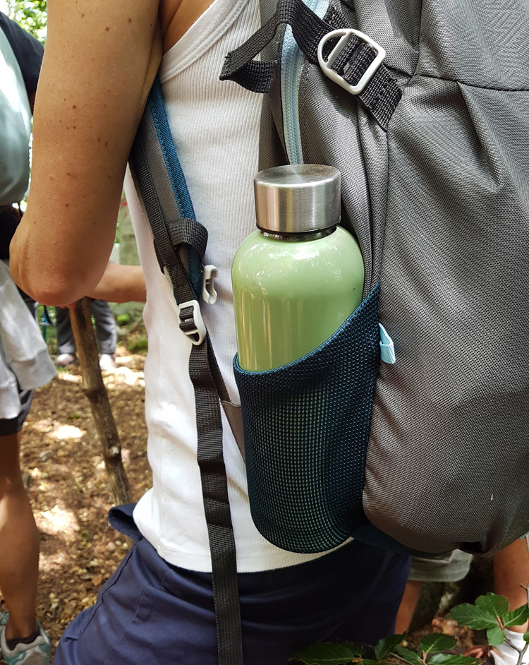 Woman Carrying Backpack with Reusable Water Bottle 